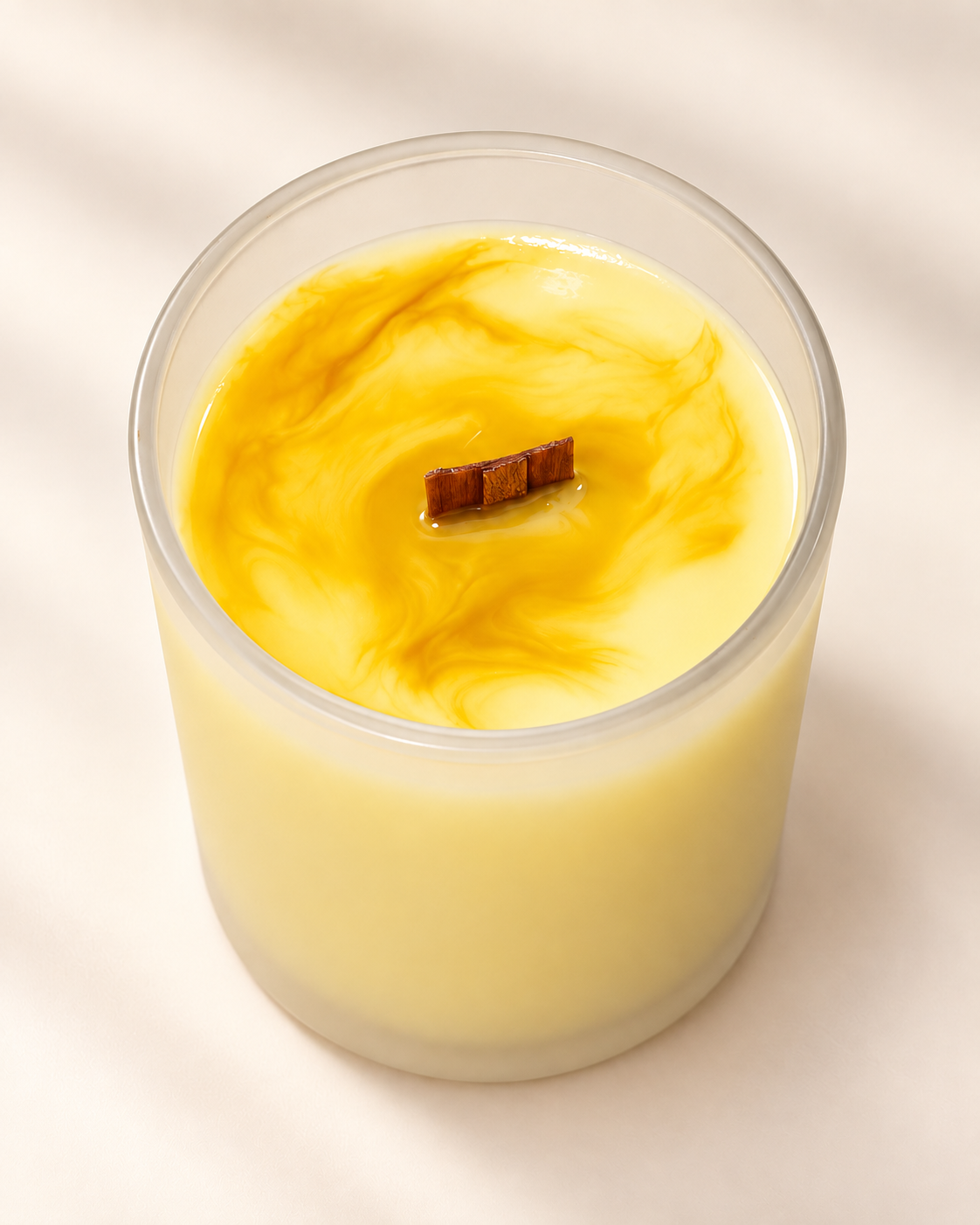 WISH Moments candle in yellow marbled soy wax with a wood wick