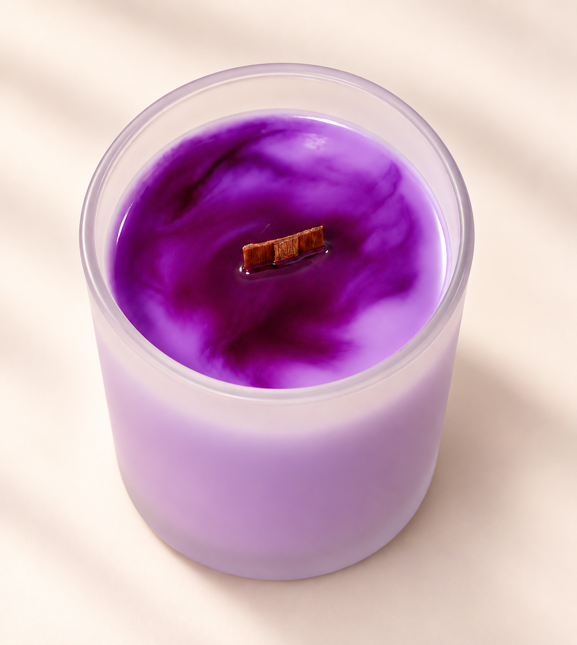WISH Moments candle in purple marbled soy wax with a wood wick